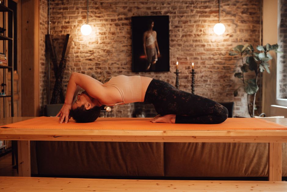 A student holding a grounded standing pose in warm natural light