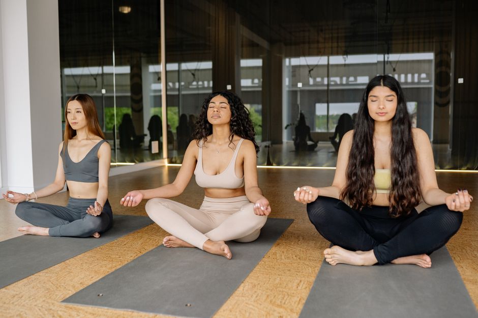 Students seated together in quiet meditation before class