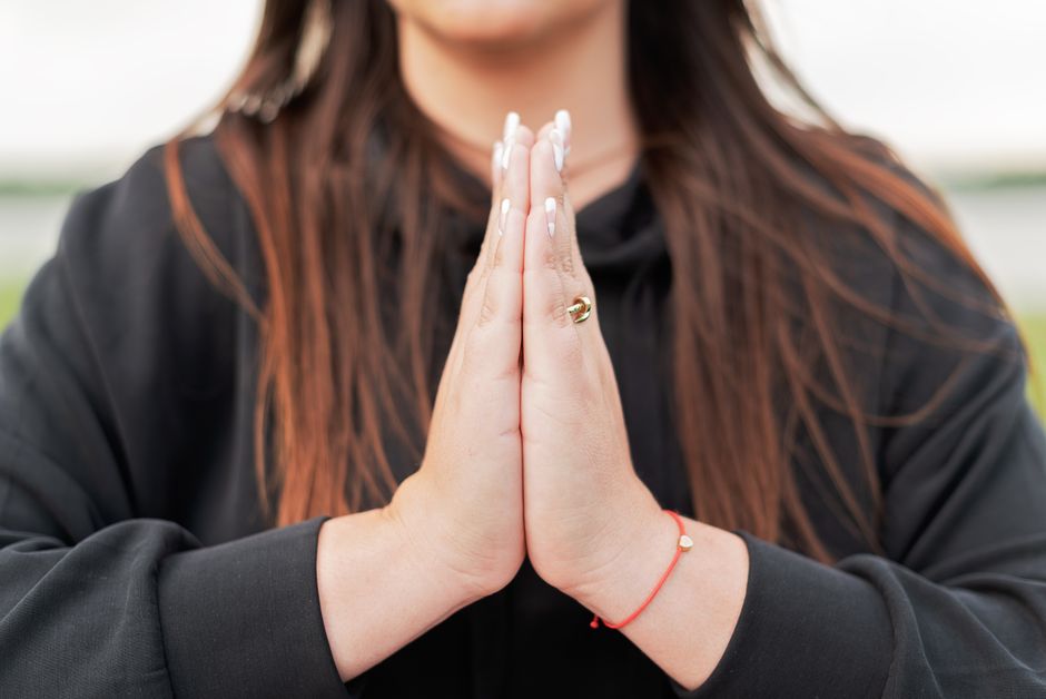 A close view of hands held in a quiet prayer position