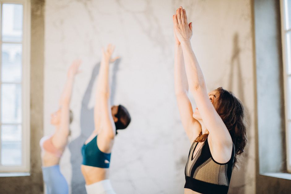 A sun salutation sequence practiced in warm studio light